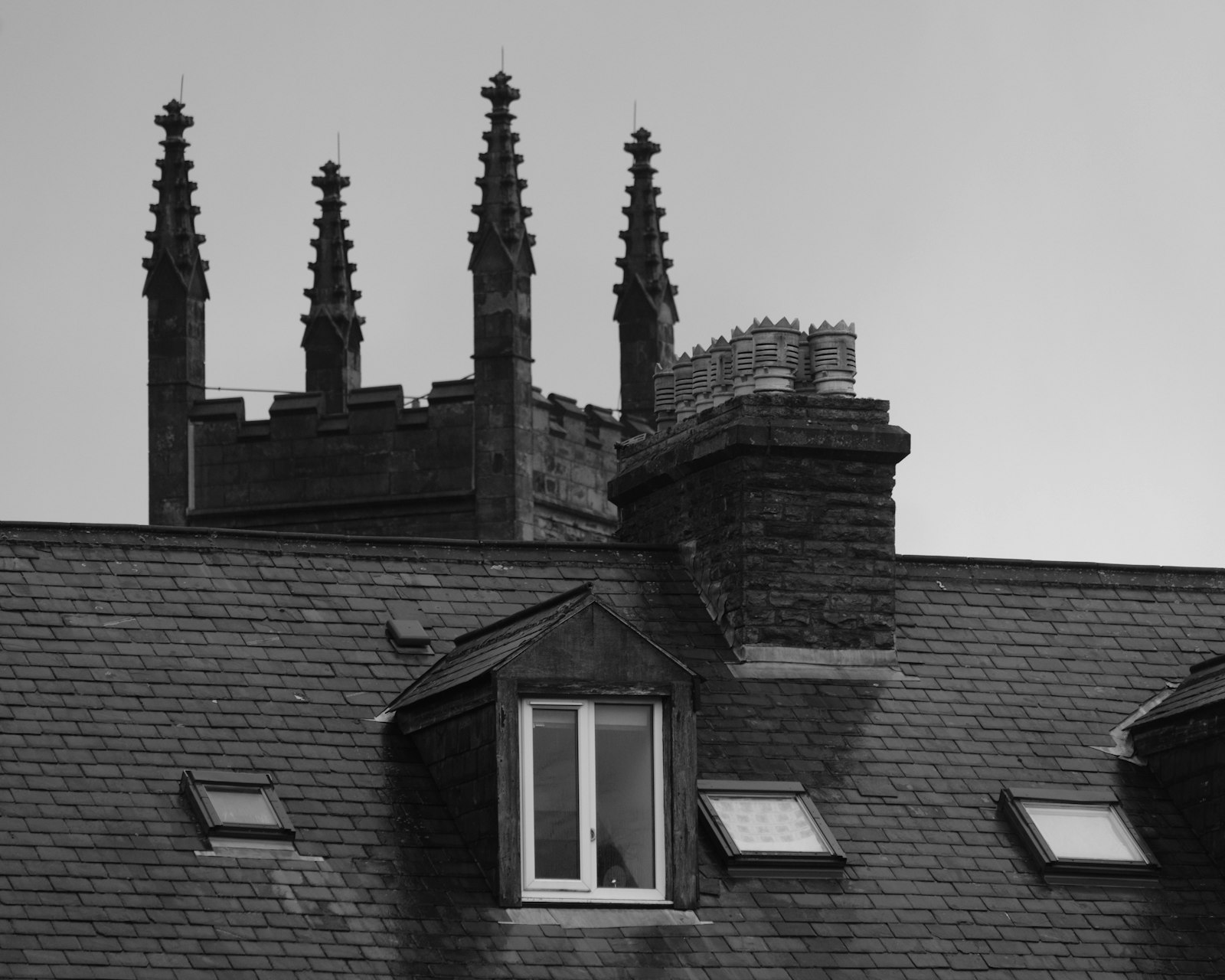 Slate roof with dormers and chimneys