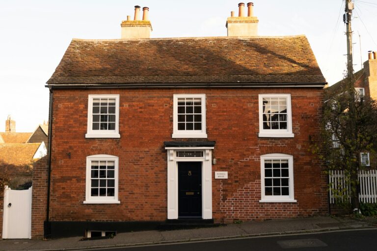 Red brick house with white windows