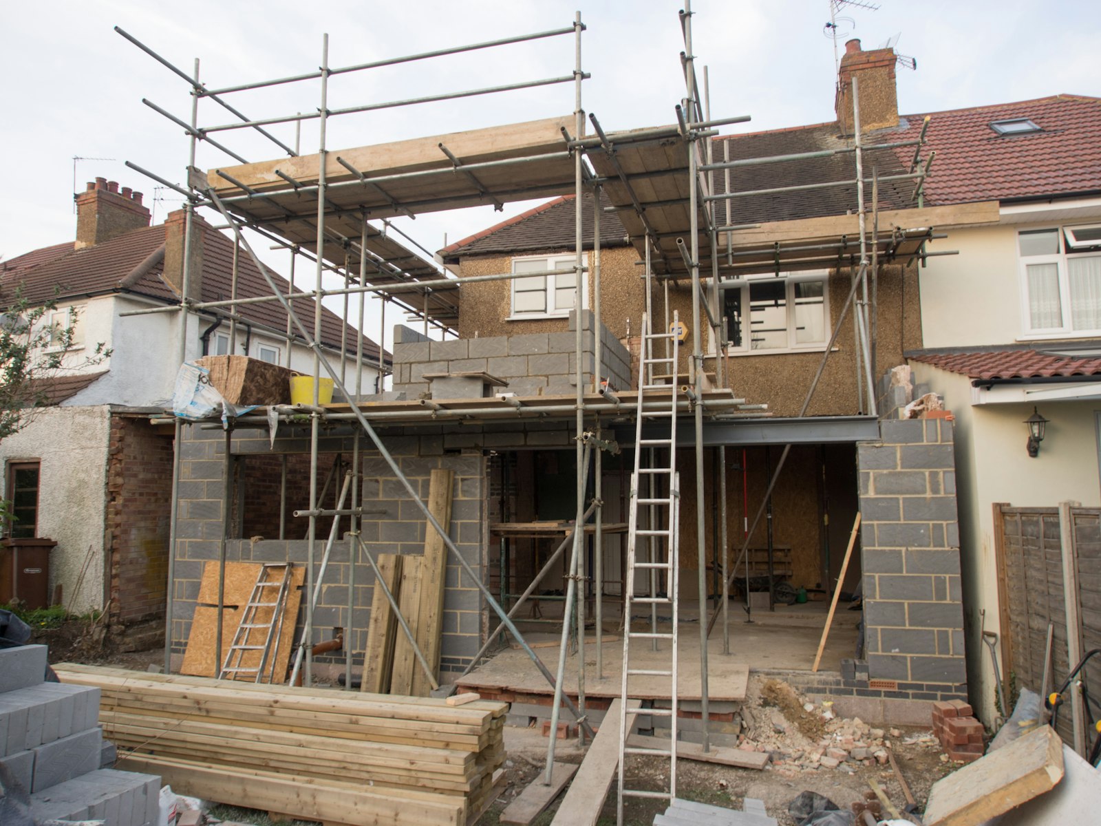 Brick house extension under construction with scaffolding